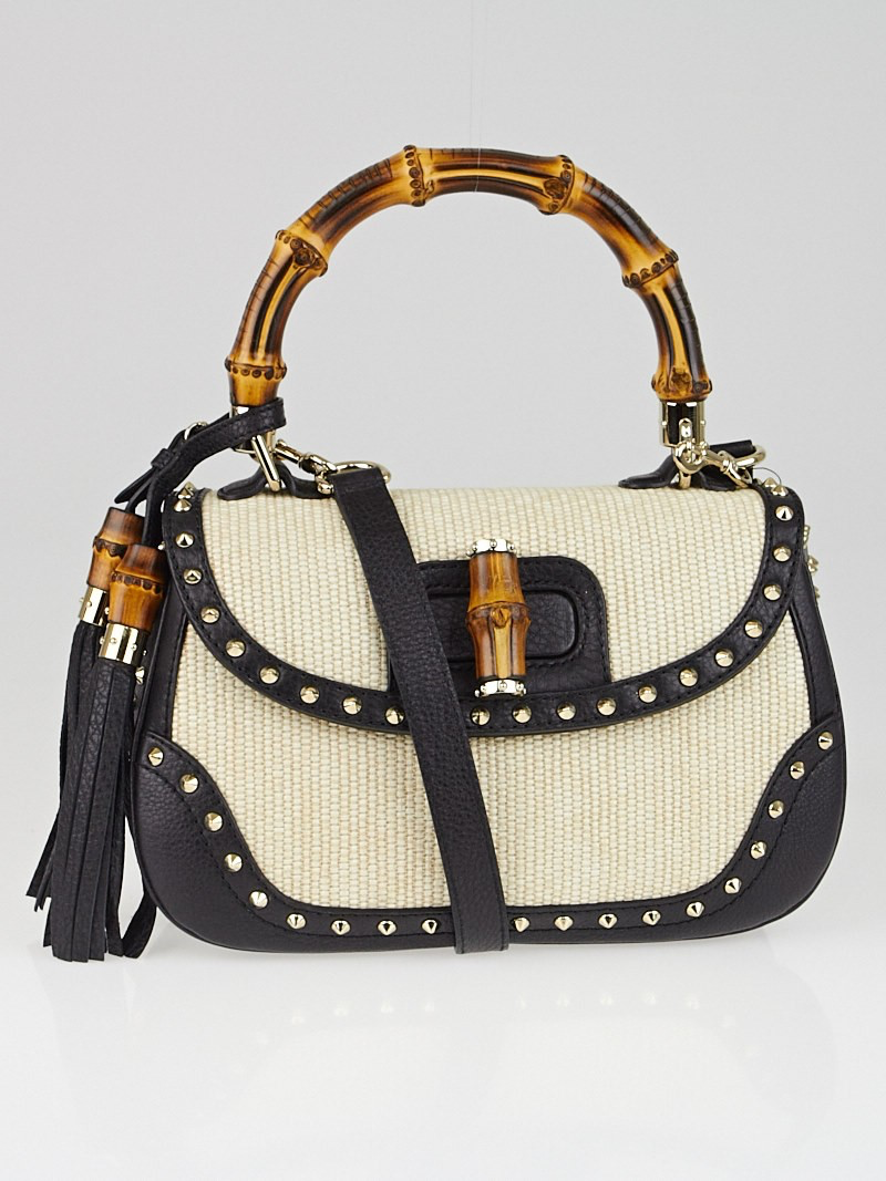 leather and straw studded bamboo top handle bag